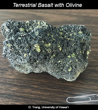 Photograph of a rock of basalt that has olivine crystals.
